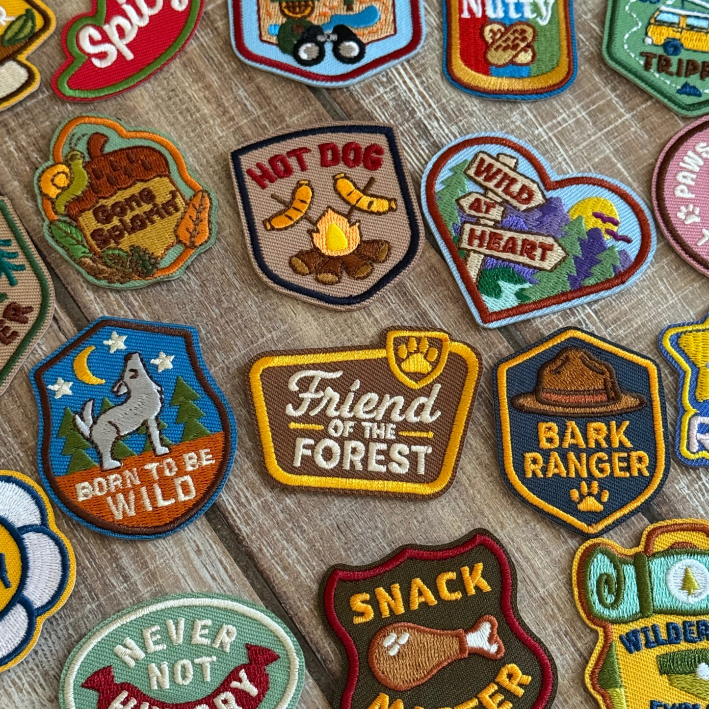 Collection of colorful embroidered patches for dogs on a wooden surface