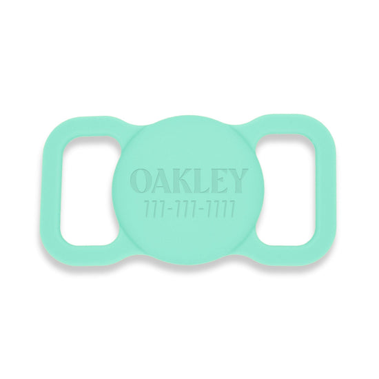 Aqua silicone AirTag holder. Pet's name and a phone # is engraved on the front.