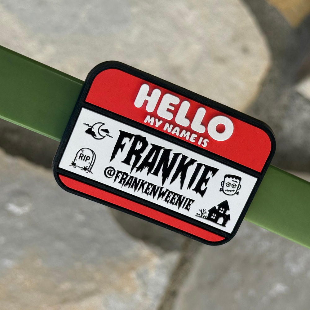 
                  
                    'Hello my name is' Pet ID Tag with the name Frankie in a halloween themed font with spooky cartoon doodles and the pet's social media handle customized on it.
                  
                