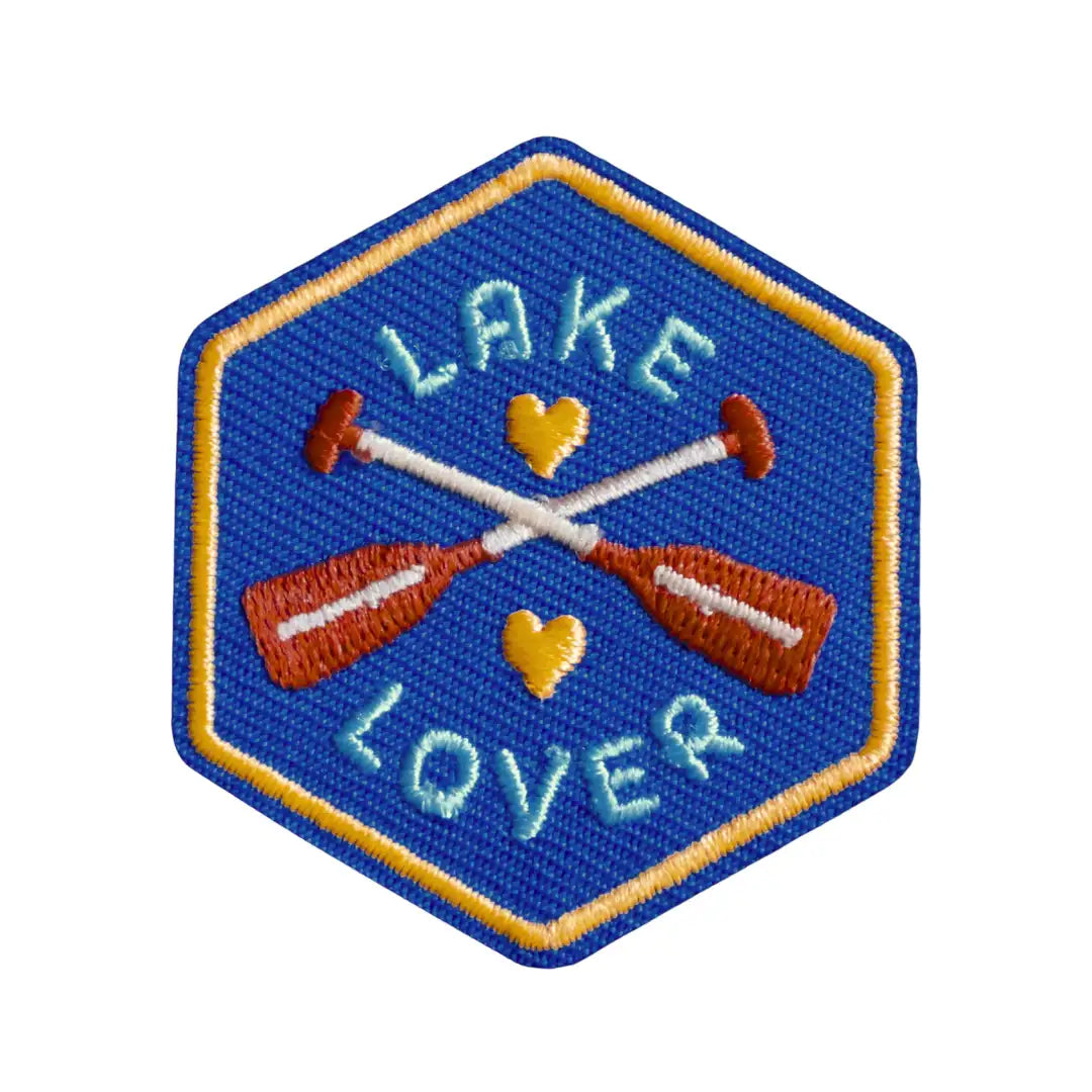 Iron-on patch with 'Lake Lover' text and crossed oars and hearts on a blue background