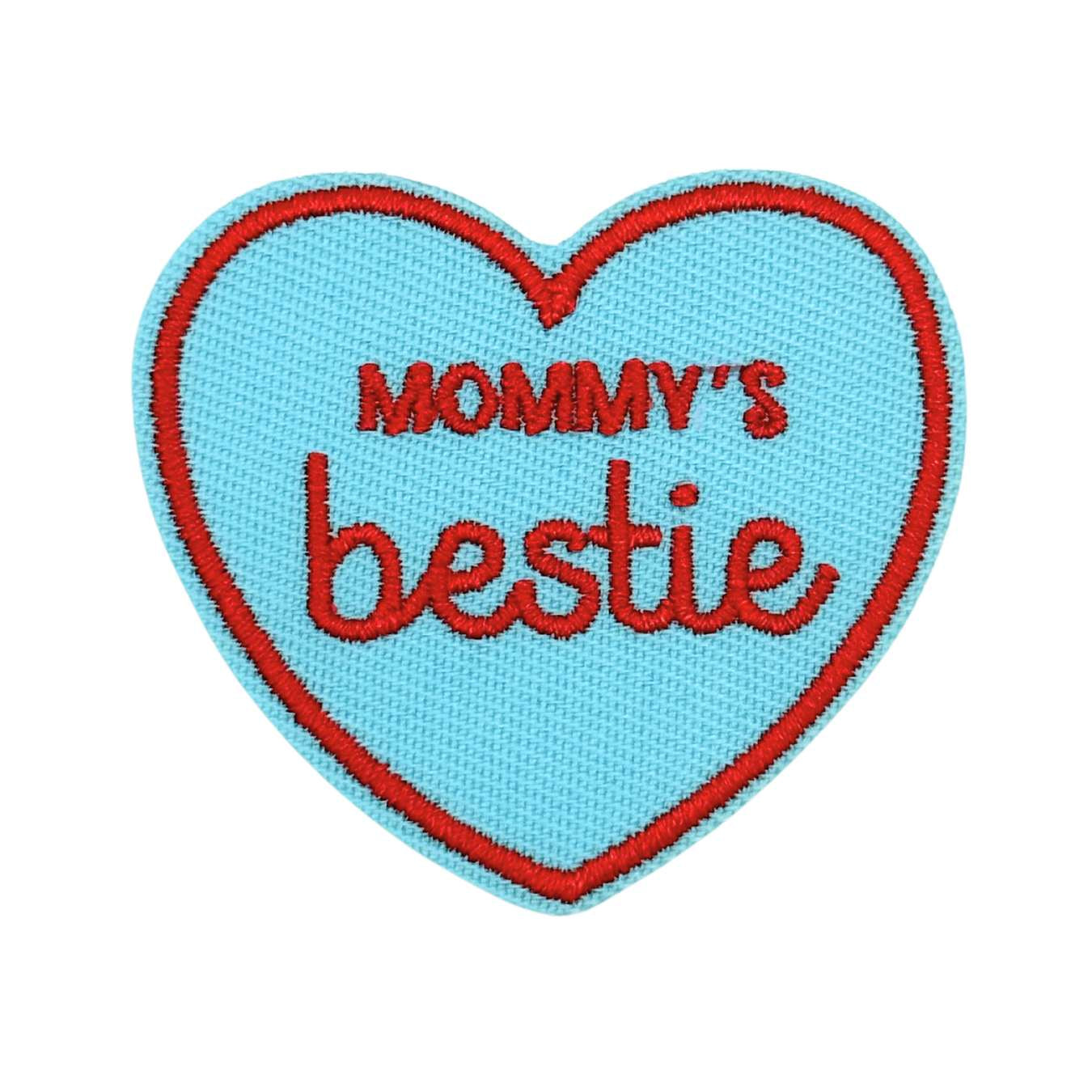 Heart-shaped patch with 'Mommy's bestie' text on a light blue background