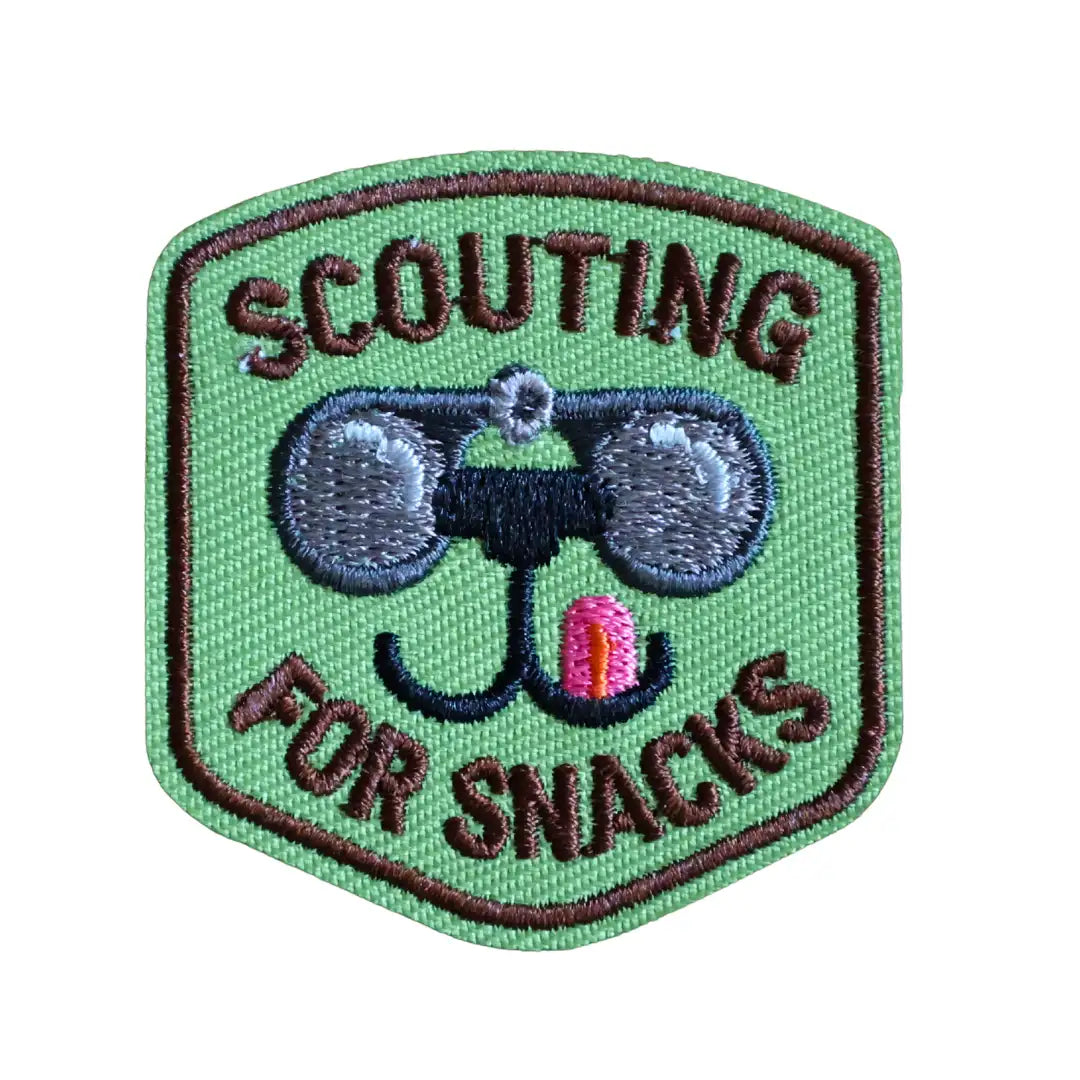 Iron-on patch labeled 'Scouting for Snacks' with a dog with binoculars illustration